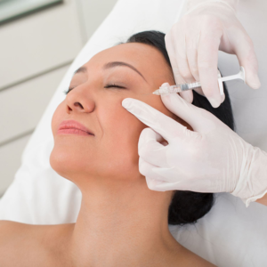 Woman receiving Botox injection near eye area to prevent wrinkles and fine lines