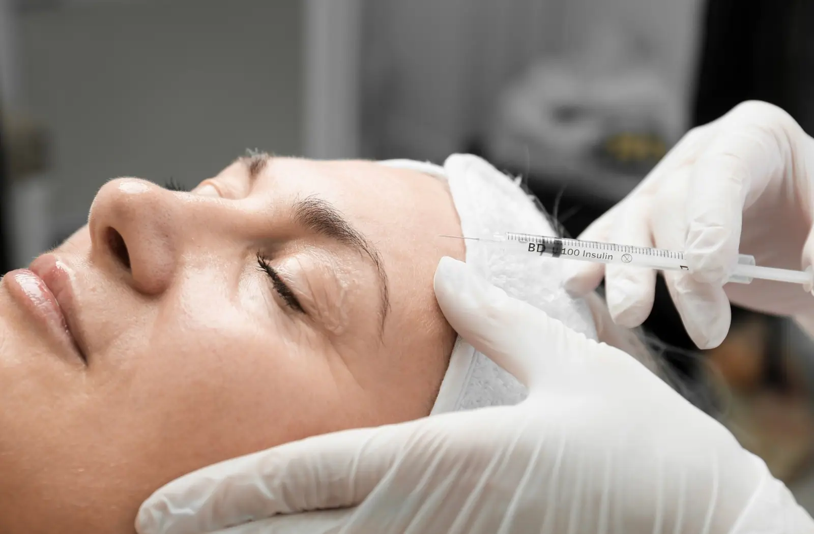 Botox injection in forehead close-up