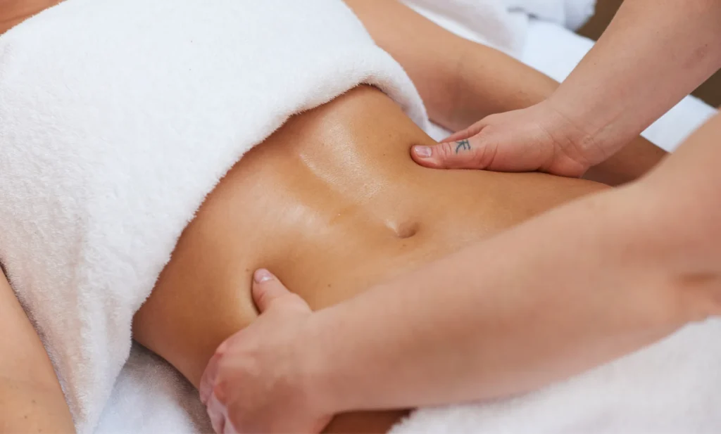 Professional abdominal lymphatic drainage massage to help tighten loose skin after weight loss at Skincare Sommelier NYC.