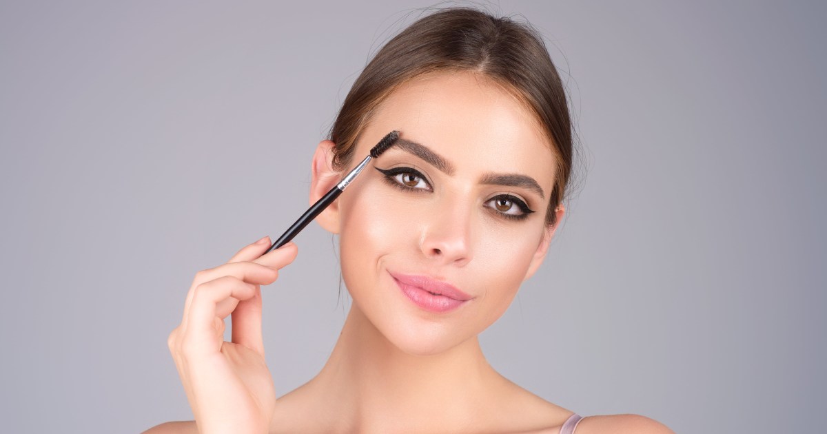 Woman grooming eyebrows with brush for perfect brow shape n Forest Hills, NY
