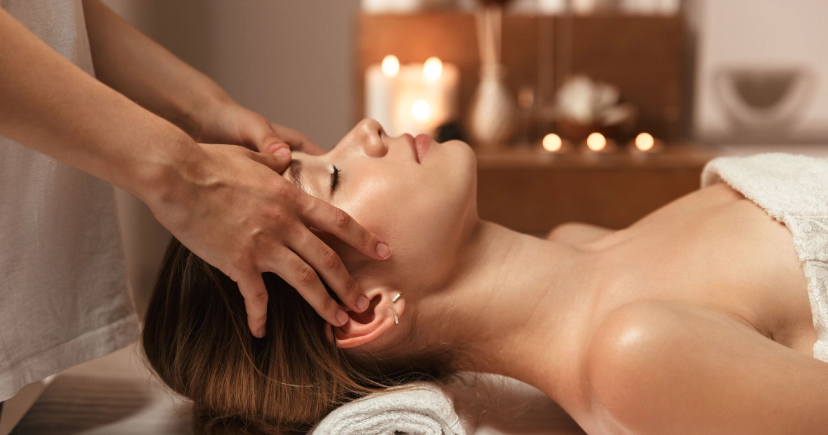Woman receiving a relaxing face massage in Forest Hills, NY spa