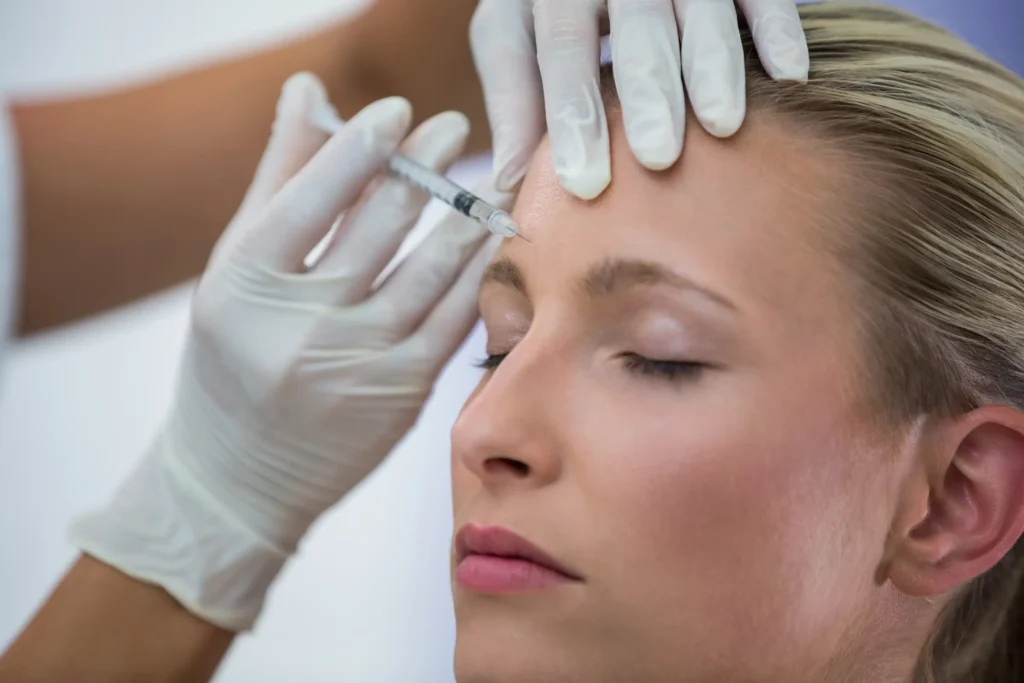 A licensed specialist administering a Botox injection into a client's forehead at Skincare Sommelier Beauty Lab & Med Spa, NYC.