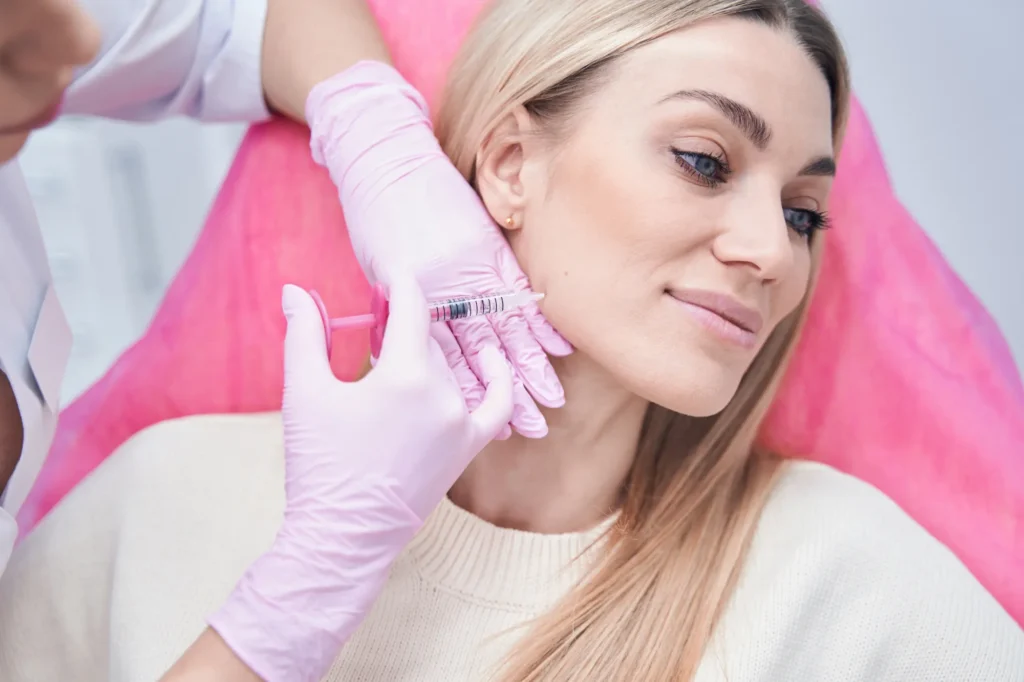 A medical professional performing a Masseter Botox injection for jaw slimming at Skincare Sommelier Beauty Lab & Med Spa in NYC.