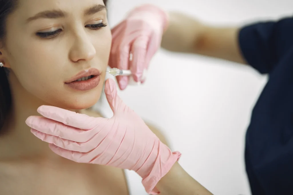Close-up of a lip filler injection procedure, focusing on safety and distinguishing normal swelling from clinical concerns at Skincare Sommelier.