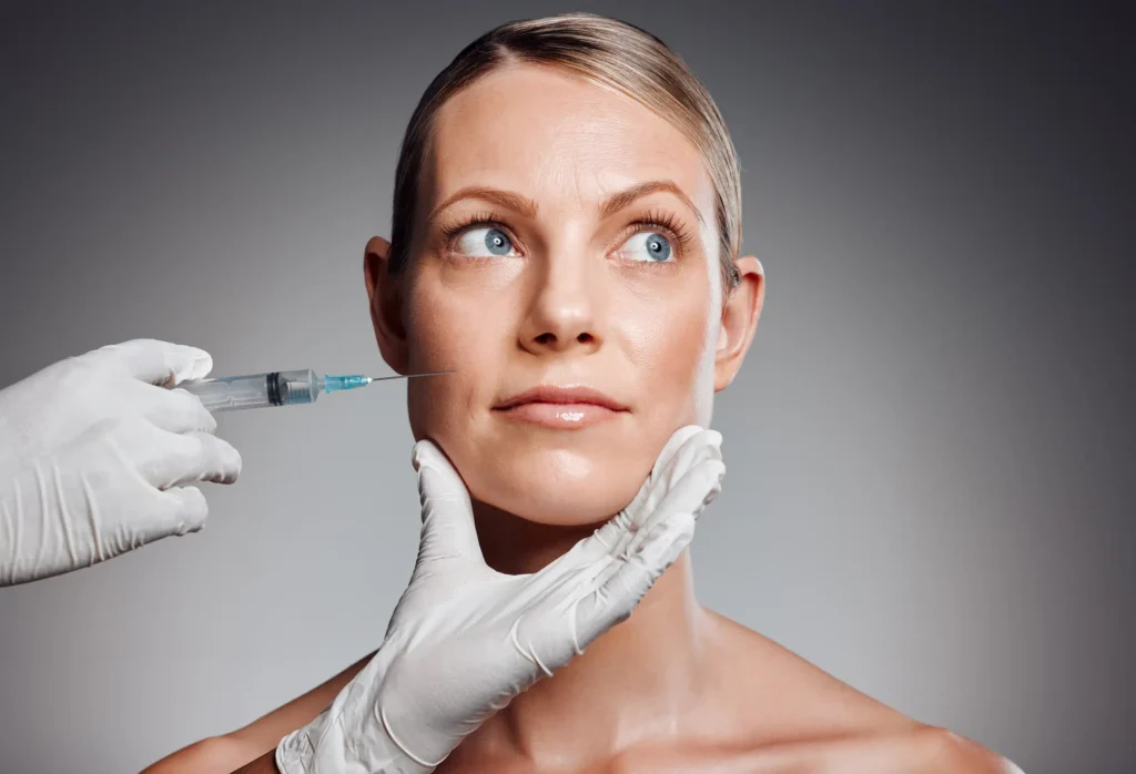A licensed aesthetic specialist performing a precise Sculptra cheek injection at Skincare Sommelier Beauty Lab & Med Spa in NYC.