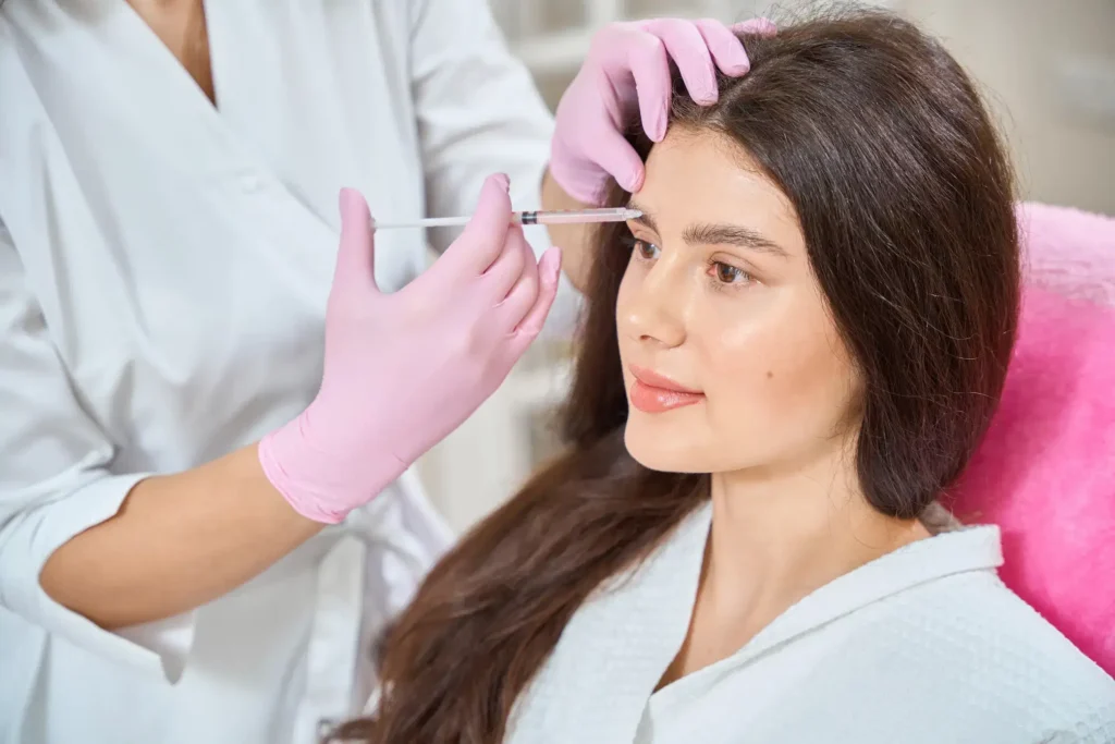 A clinical specialist performing a precise Botox cosmetic injection for dynamic wrinkle reduction at a Forest Hills med spa.