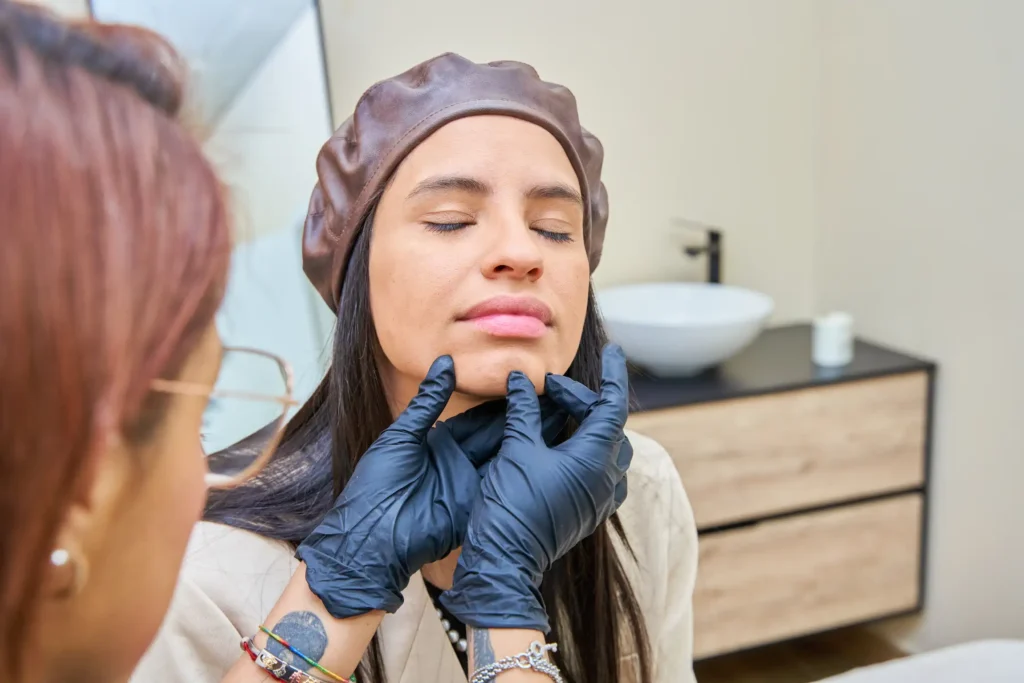 An aesthetic specialist at Skincare Sommelier consulting a client on personalized jawline slimming, contouring, and chin projection goals.