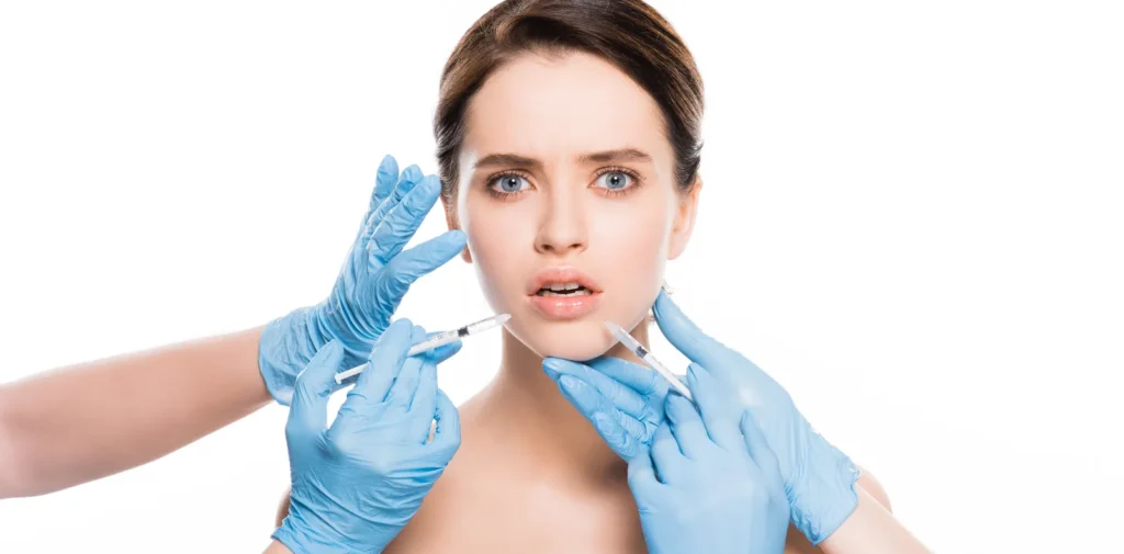 Provider injecting dermal filler near the lips, one of the facial danger zones covered in this guide